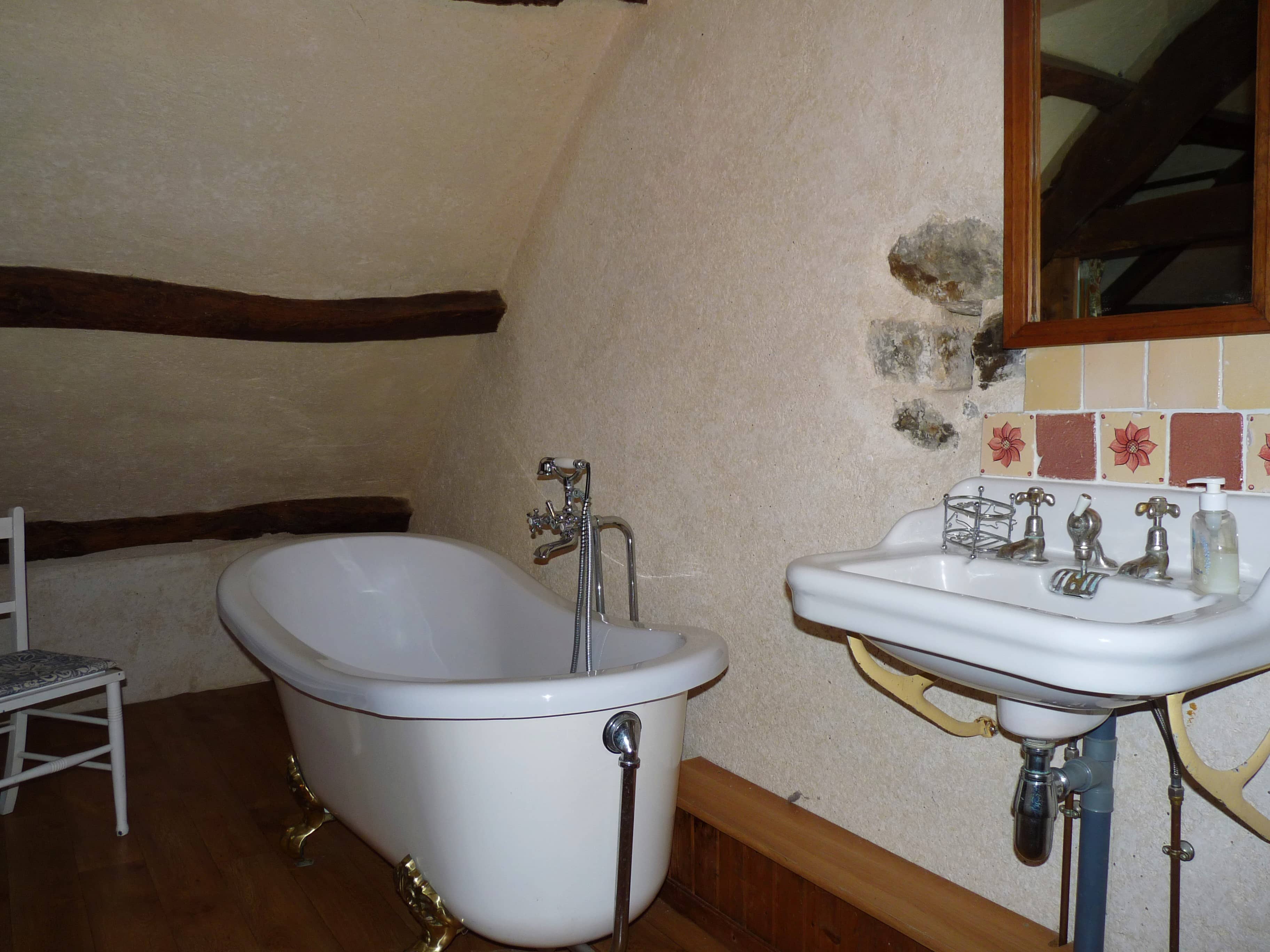 Modern and elegant bathroom of La Julerie cottage in Brittany, France, with a walk-in shower, mosaic tiles, and high-end amenities. Ideal for freshening up after a day of sightseeing in Brittany.